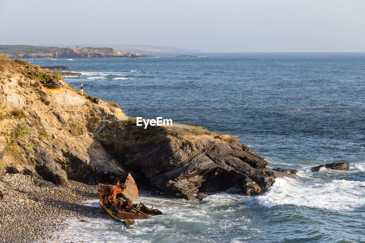 SCENIC VIEW OF ROCKS IN SEA AGAINST SKY