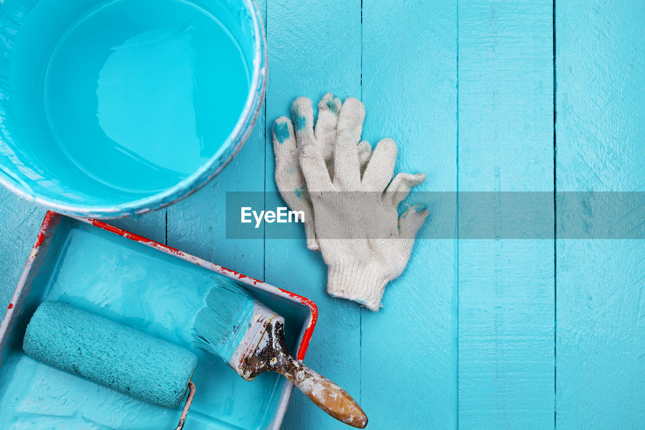 Directly above shot of paint and equipment on table