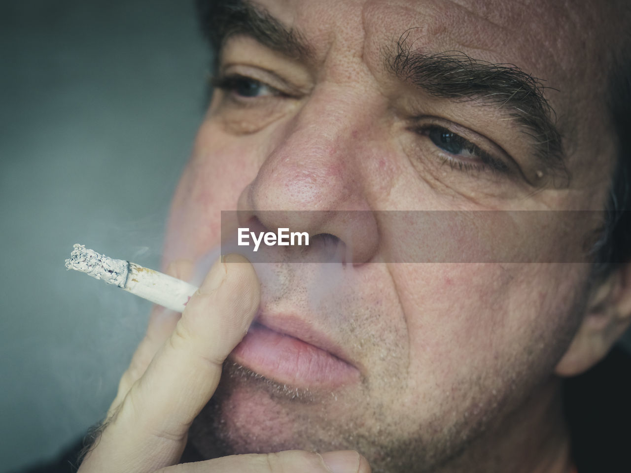 Close-up of man smoking cigarette