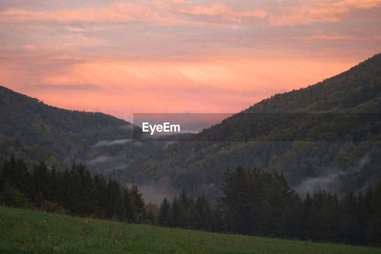 Autumn fog in beautiful landscape at sunset, view in the valley