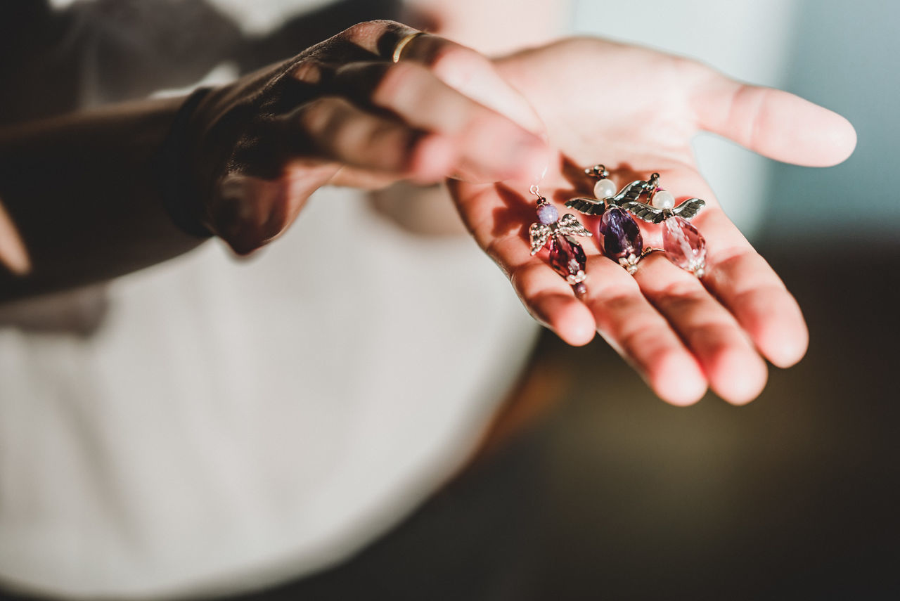 Close-up of hand holding medallions