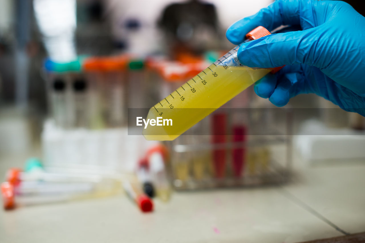 Cropped hand examining in laboratory