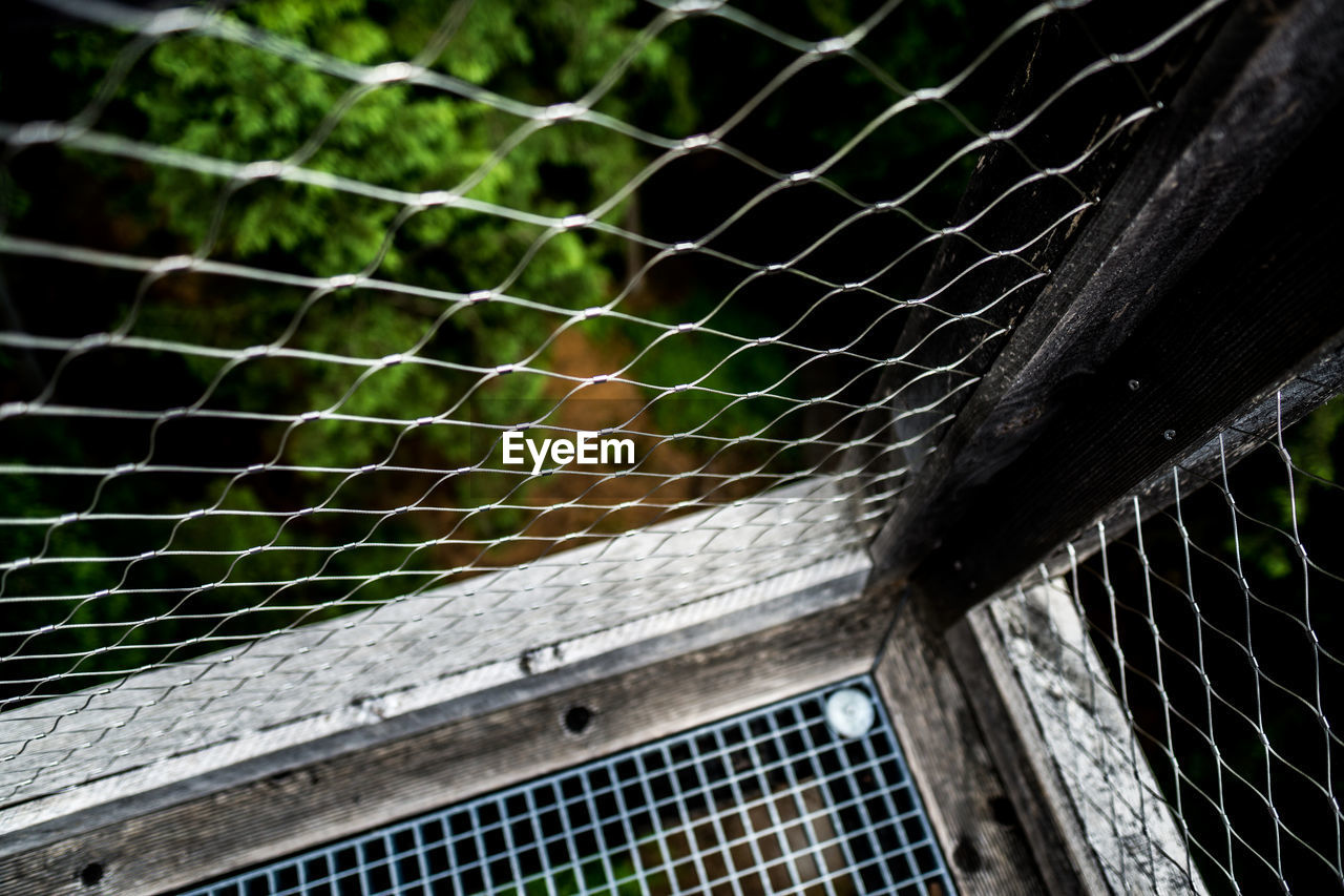 LOW ANGLE VIEW OF A FENCE IN A GREEN NET