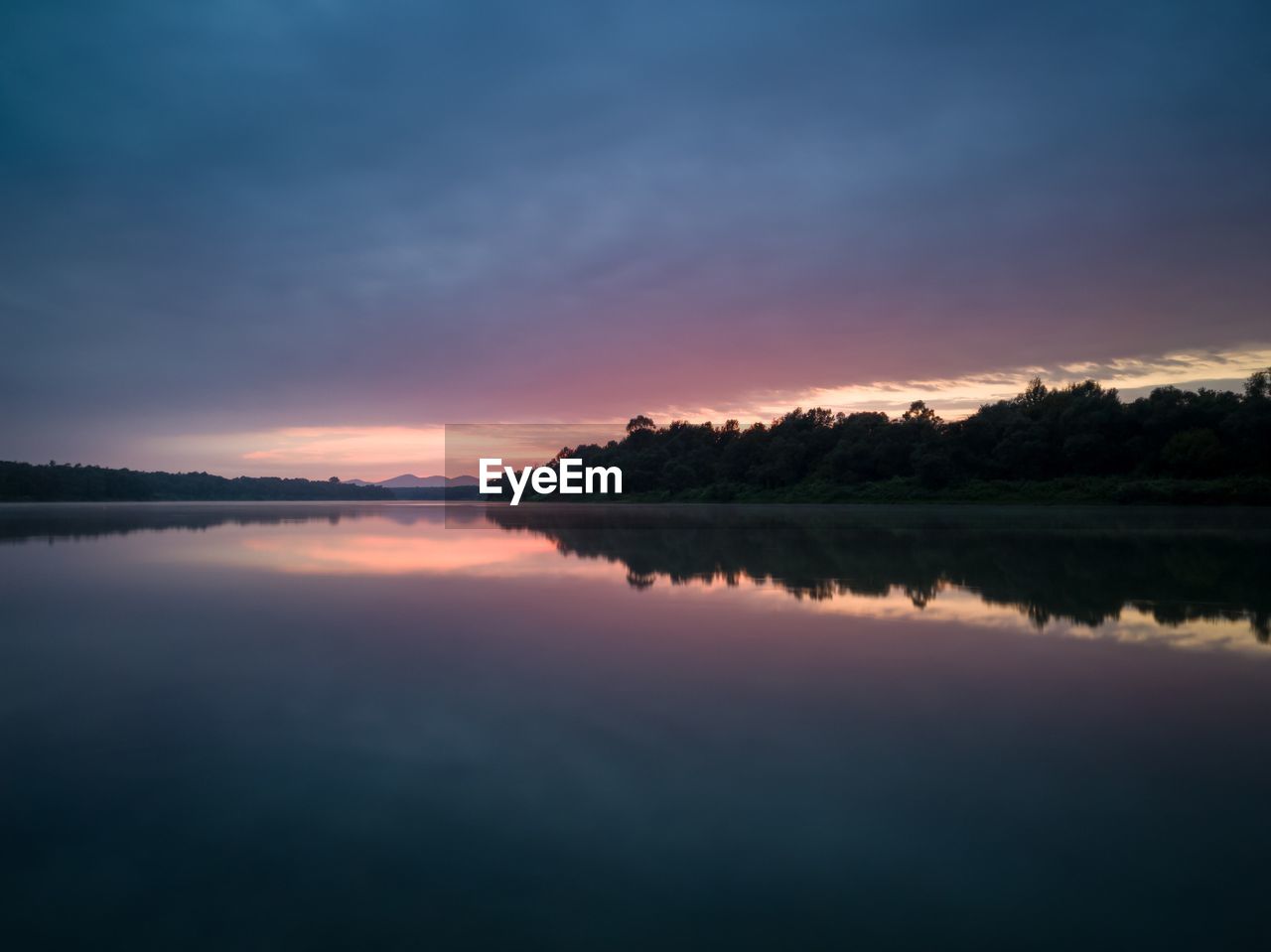 Scenic view of river against romantic sky at sunset