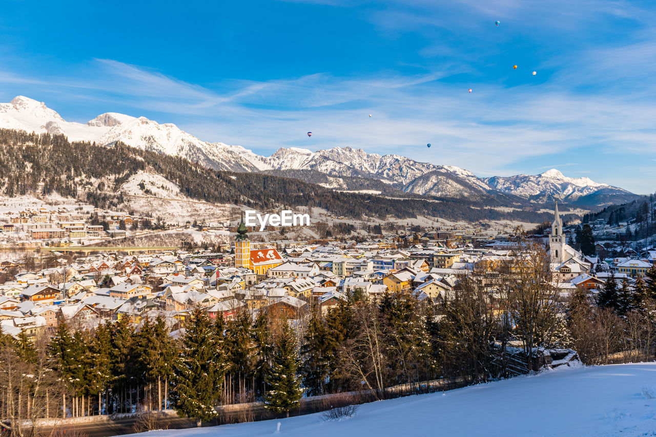 Scenic view of snowcapped city, ski resort schladming and mountains against sky