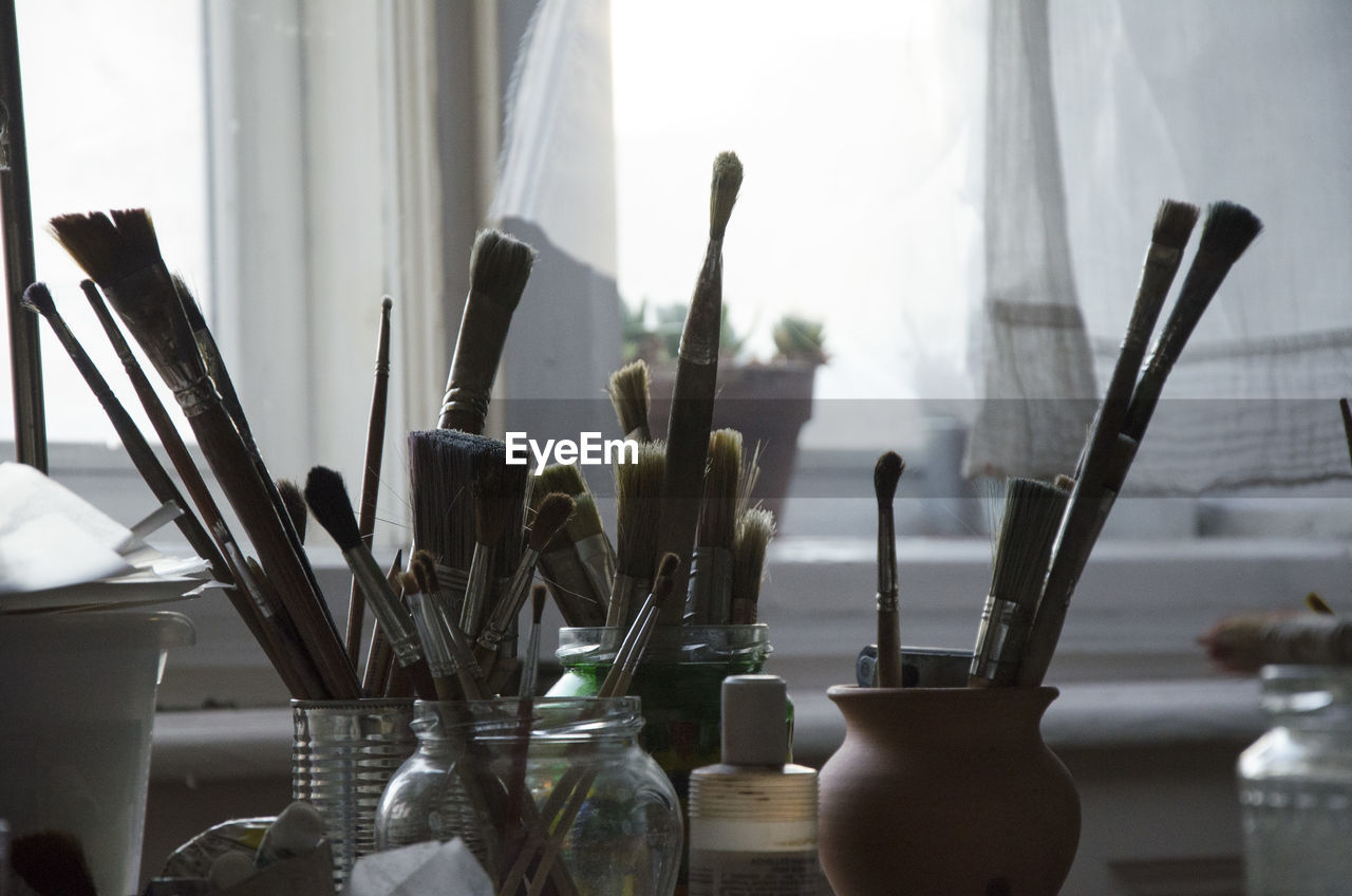 Close-up of paintbrushes on table at home