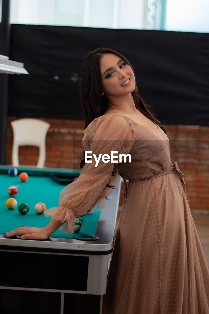 Beautiful woman at the pool table