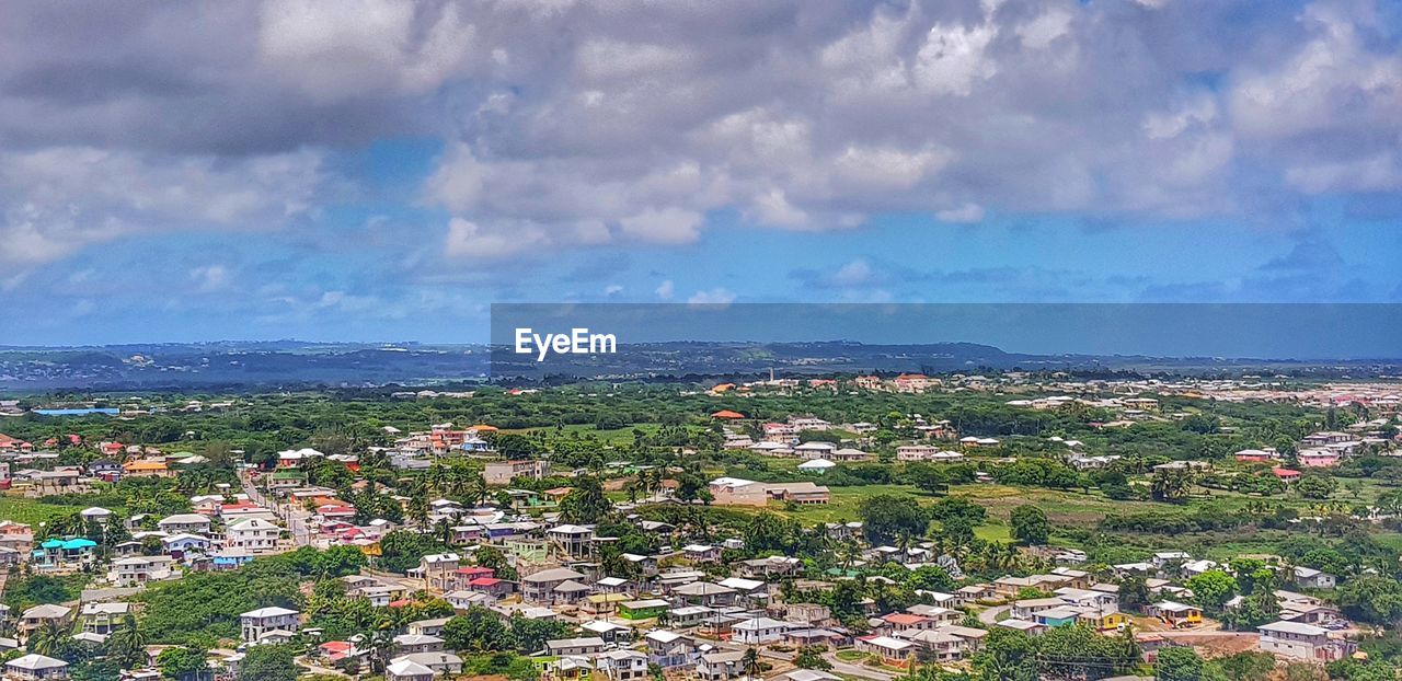 cloud - sky, building exterior, architecture, sky, built structure, city, residential district, cityscape, building, nature, high angle view, day, no people, outdoors, town, mountain, environment, community, townscape, settlement