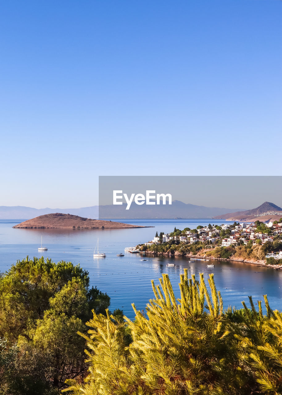 Scenic view of sea against clear blue sky