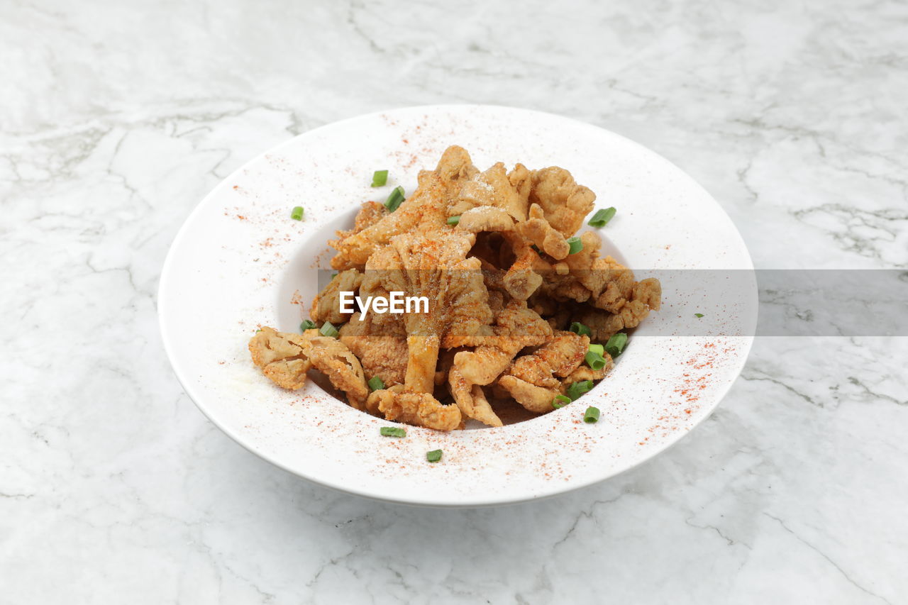 Delicious fried mushroom serve on white plate