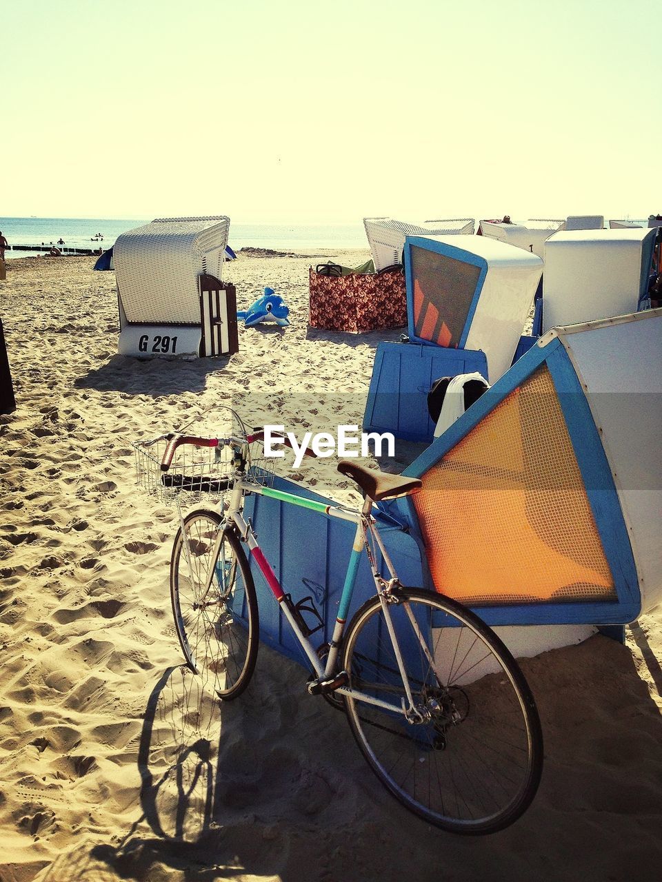 Bicycle and hooded chairs on beach