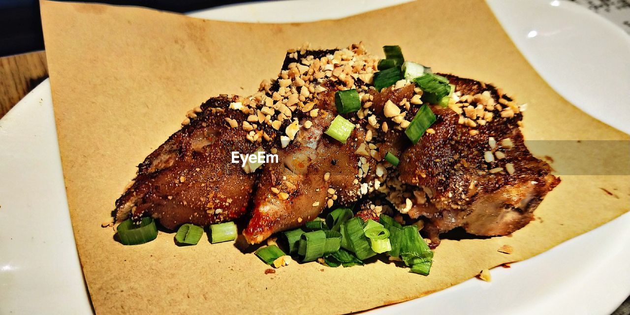 CLOSE-UP OF MEAT AND SALAD ON PLATE