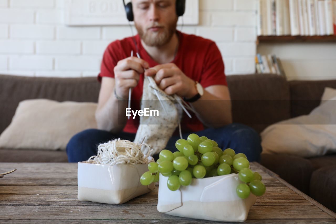 Man knitting at home