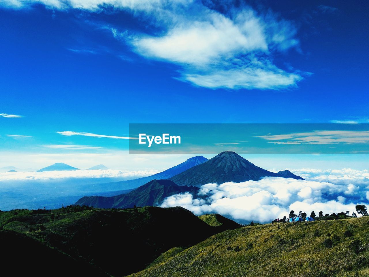 Scenic view of mountains against blue sky