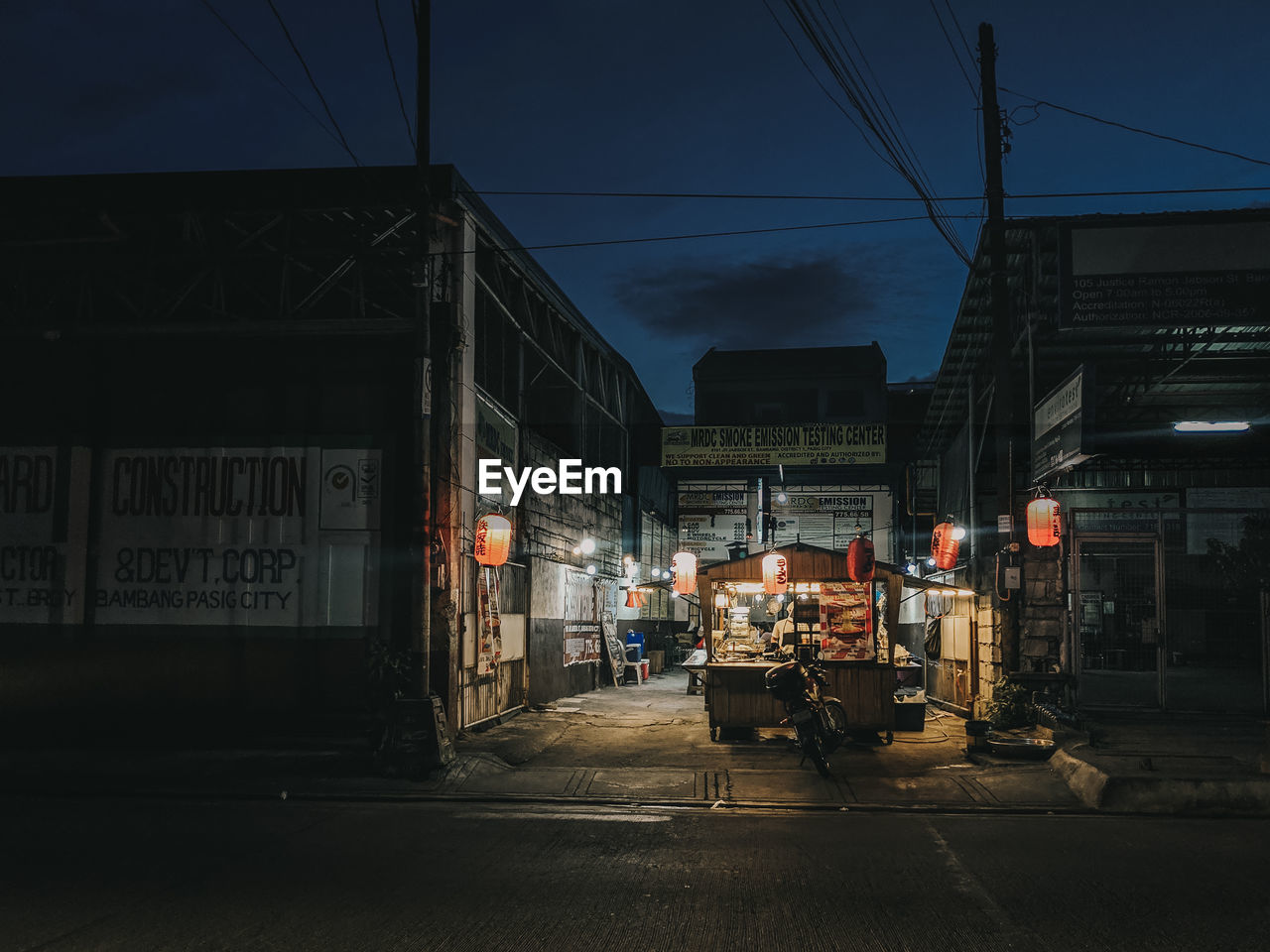 CARS ON ILLUMINATED STREET AT NIGHT