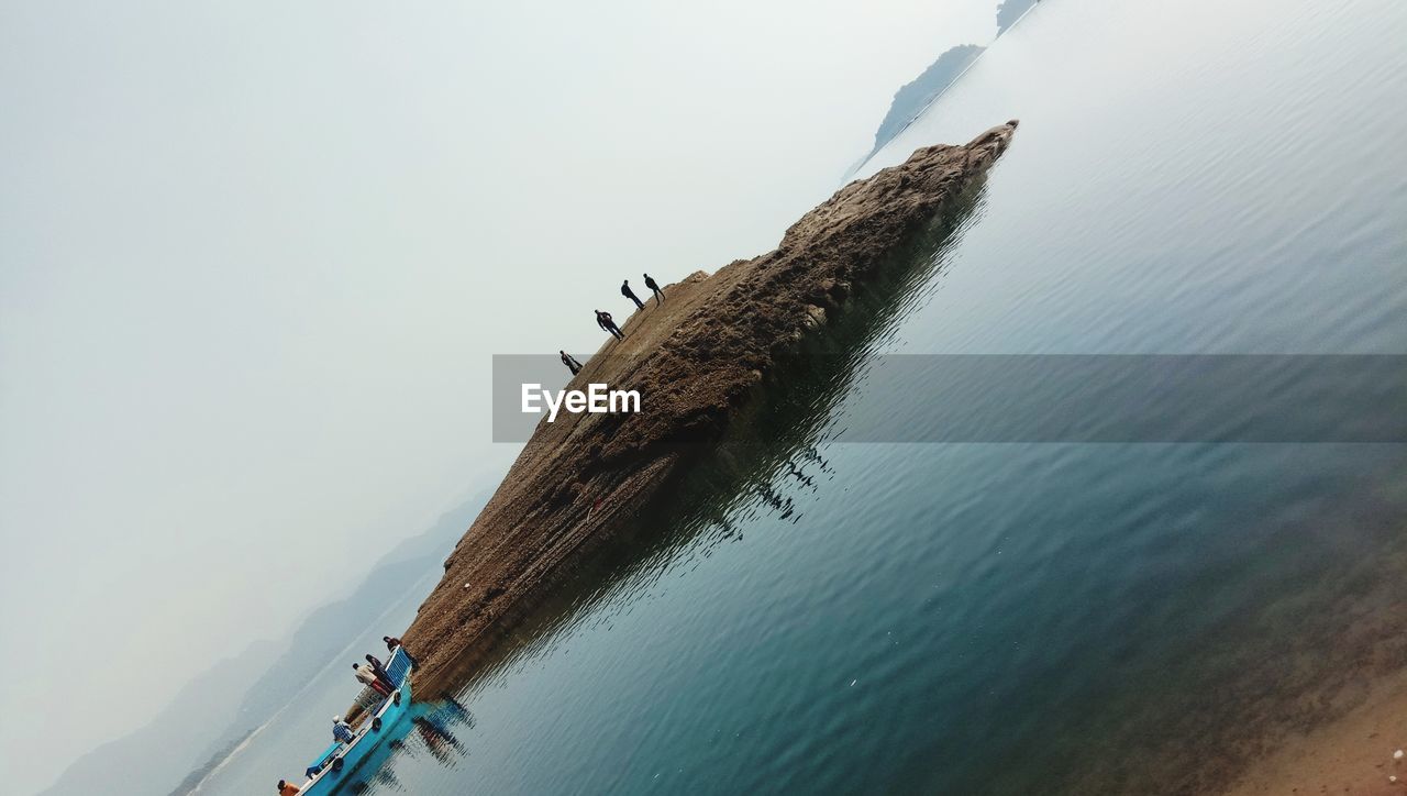 HIGH ANGLE VIEW OF SHIP BY SEA AGAINST SKY