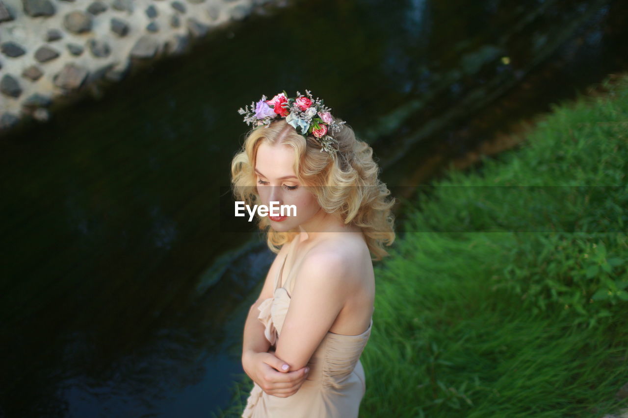 High angle view of beautiful bride standing on grass