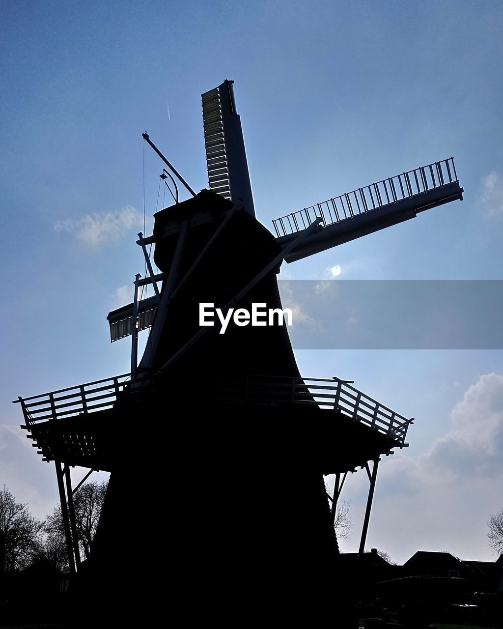 LOW ANGLE VIEW OF TRADITIONAL WINDMILL AGAINST SKY WITH SILHOUETTE WINDMILLS