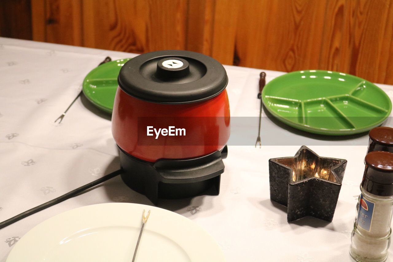 CLOSE UP OF RED AND OBJECTS ON TABLE