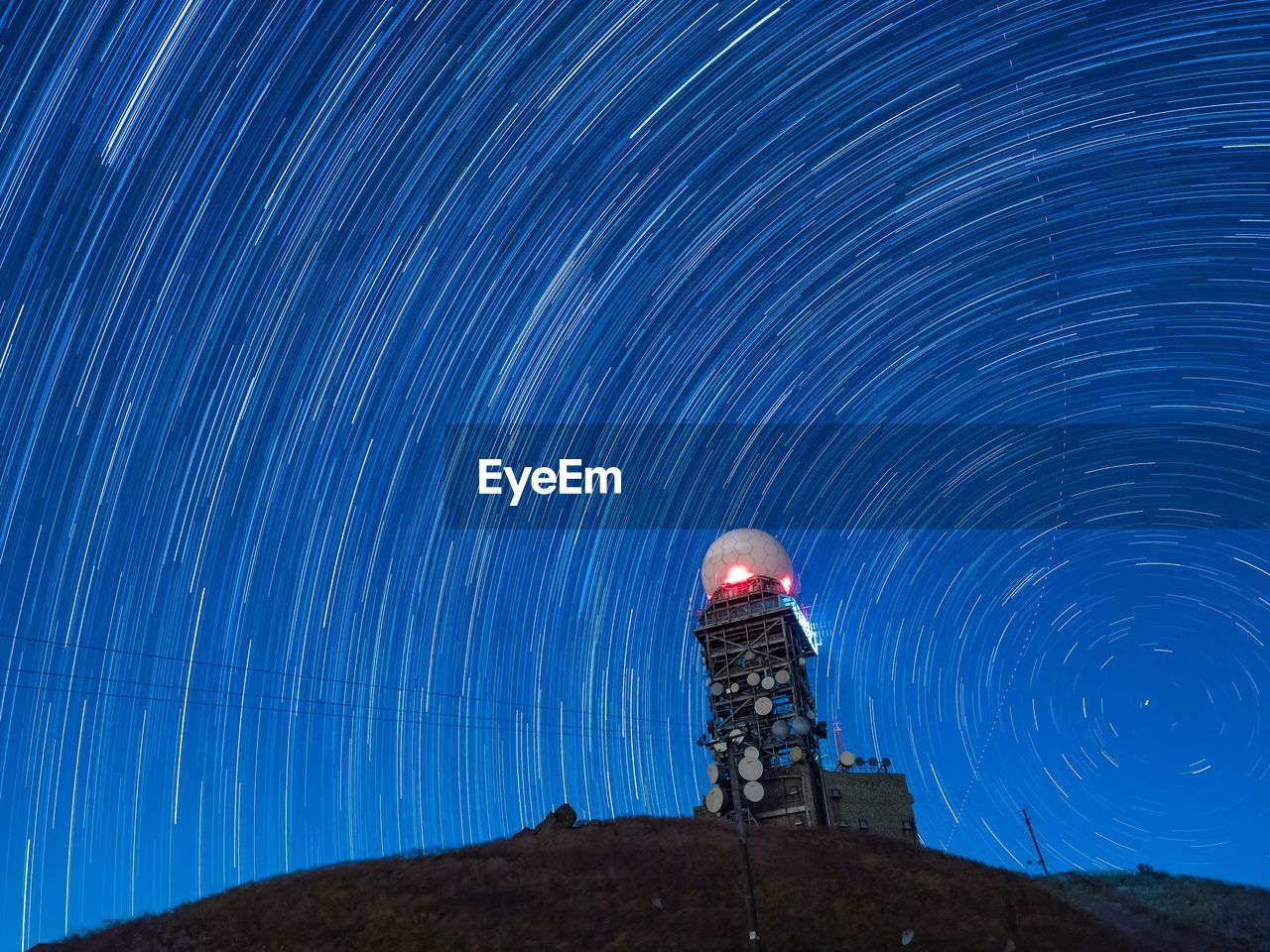 Low angle view of light painting against sky at night