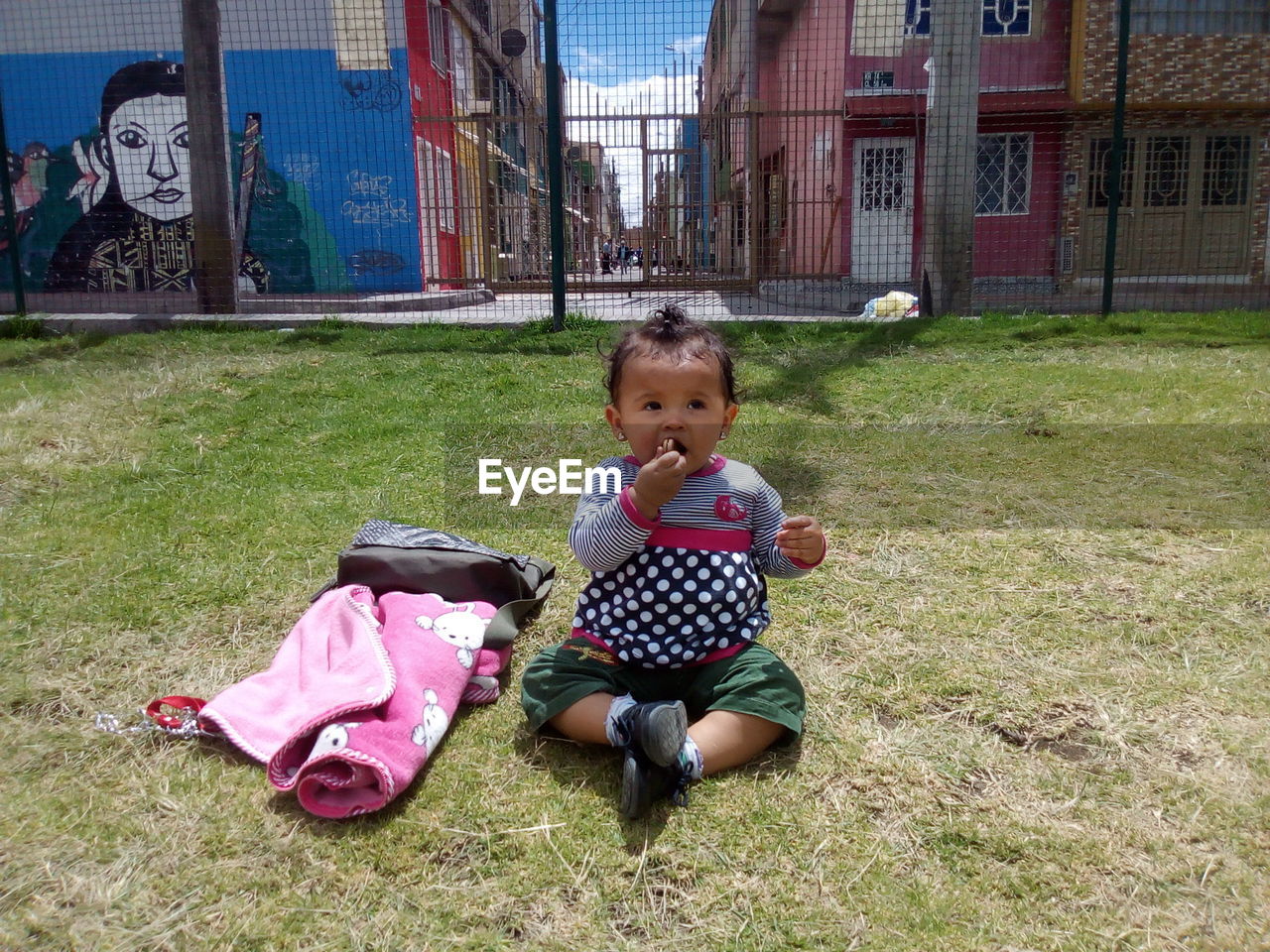 BOY SITTING ON GRASS