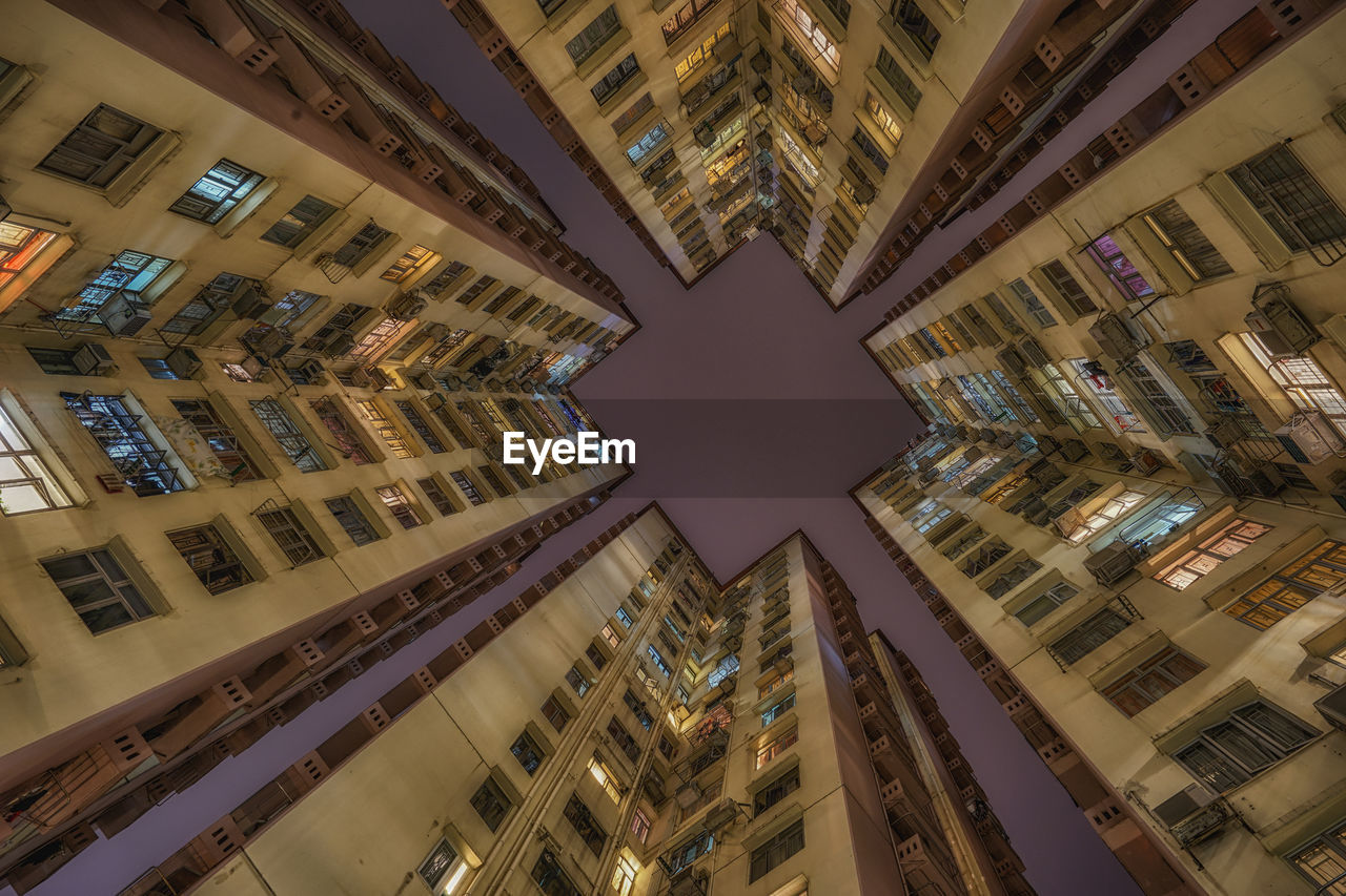 Directly below shot of buildings against sky