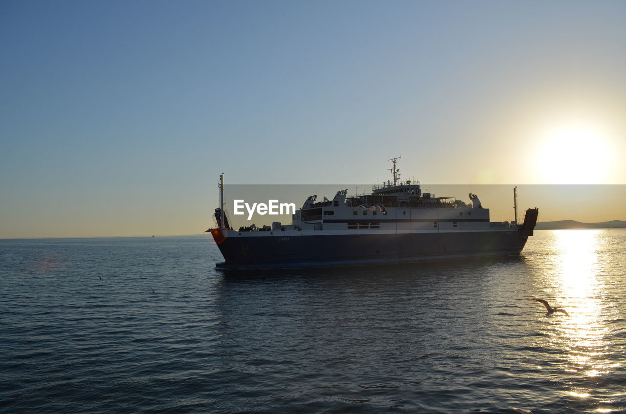 SHIP SAILING IN SEA AGAINST CLEAR SKY