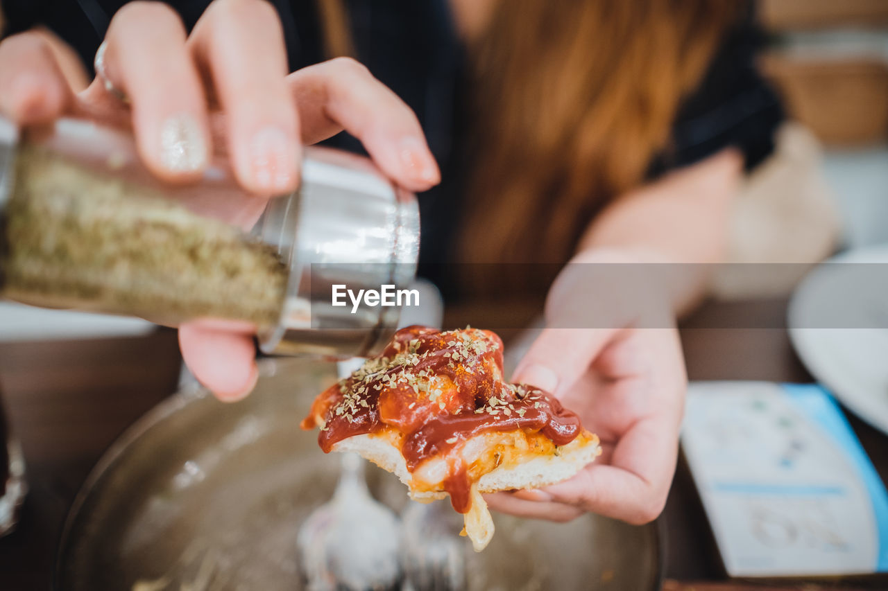 Midsection of woman holding pizza