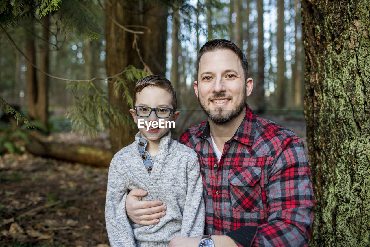 Portrait of young dad holding his son.