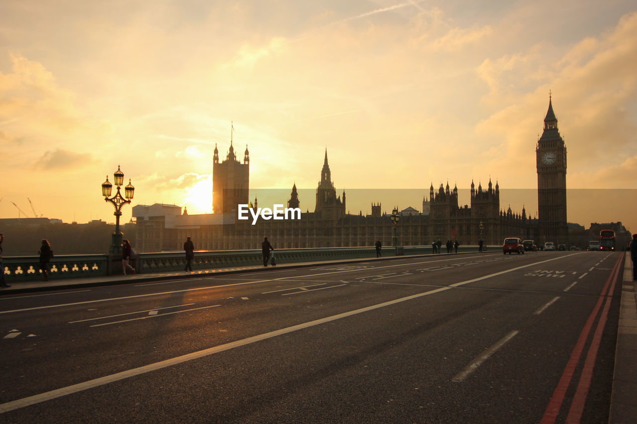Westminster bridge and big ben against sky during sunset