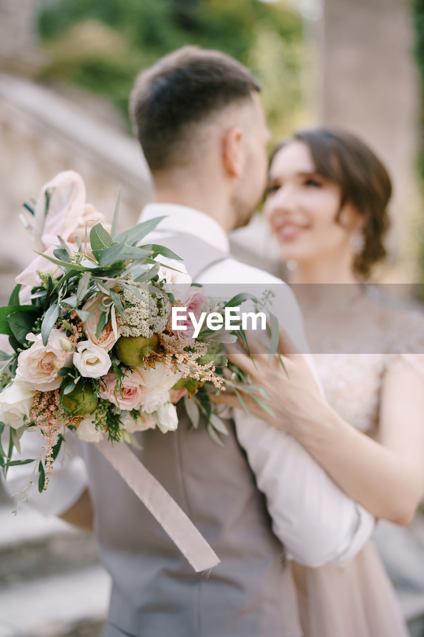 side view of bride holding bouquet