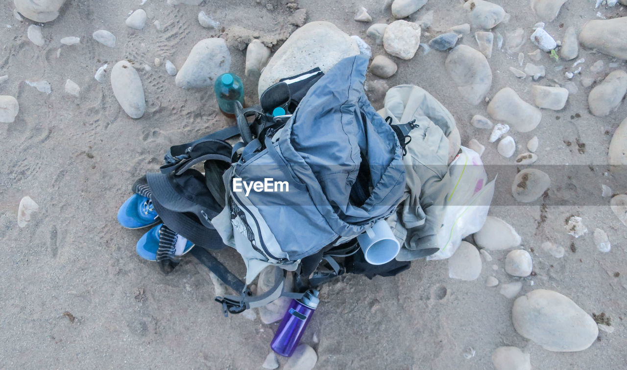 HIGH ANGLE VIEW OF MAN CLIMBING ON GROUND