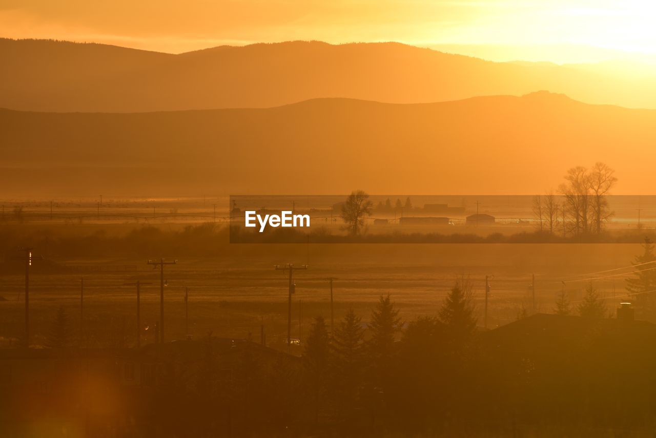 SCENIC VIEW OF LANDSCAPE AGAINST SKY AT SUNSET