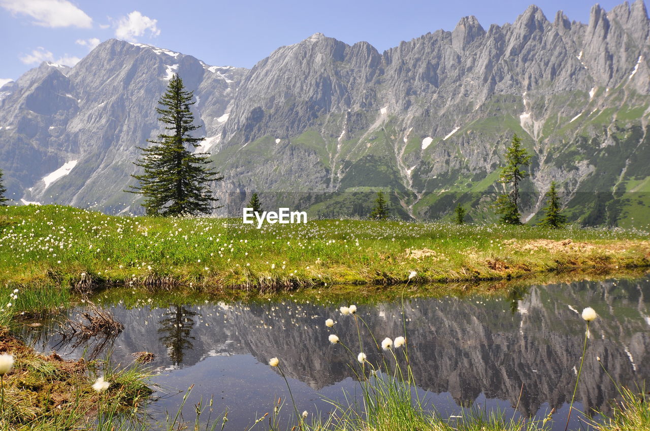 Scenic view of lake and mountains against sky