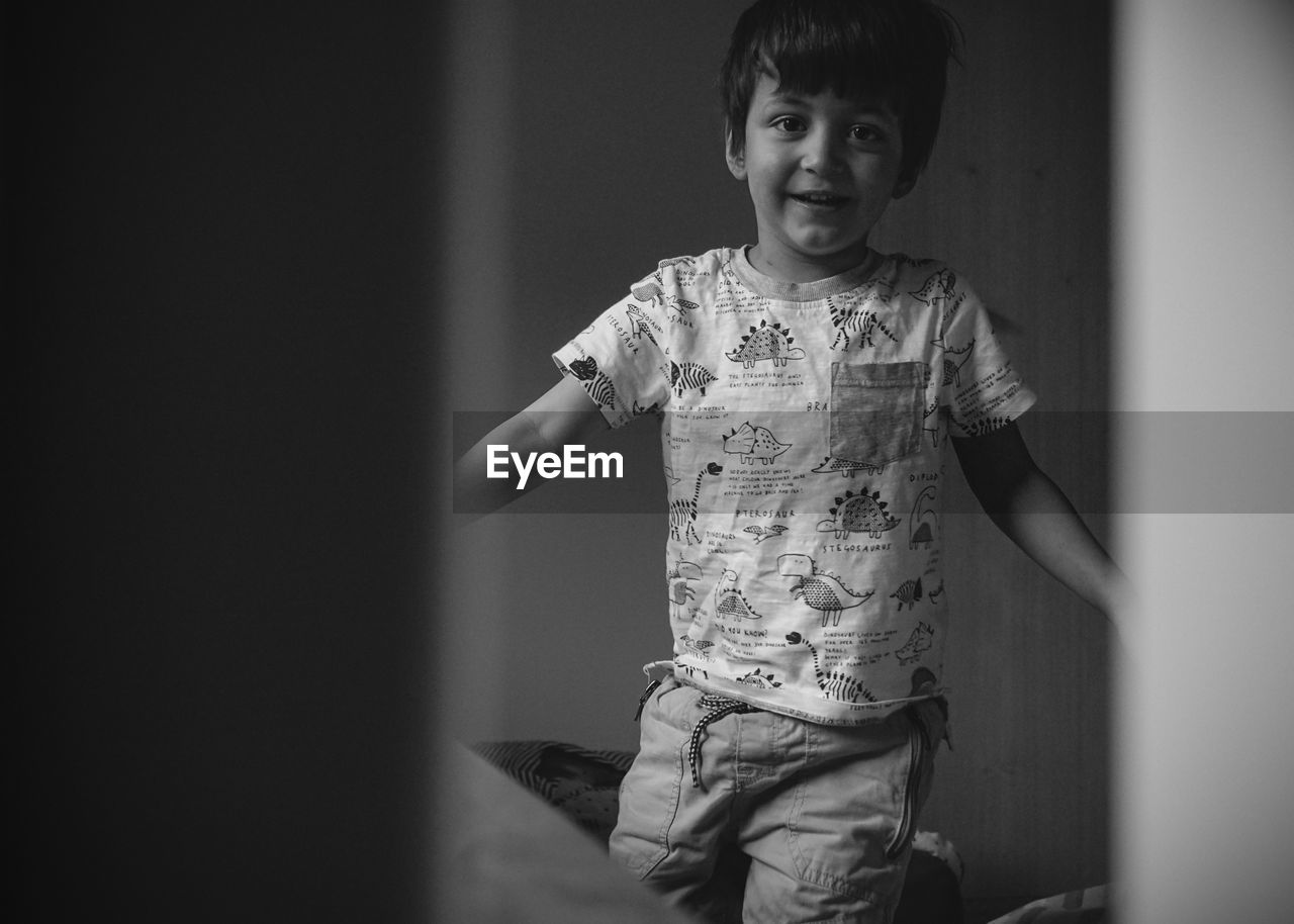 PORTRAIT OF BOY STANDING IN HOME