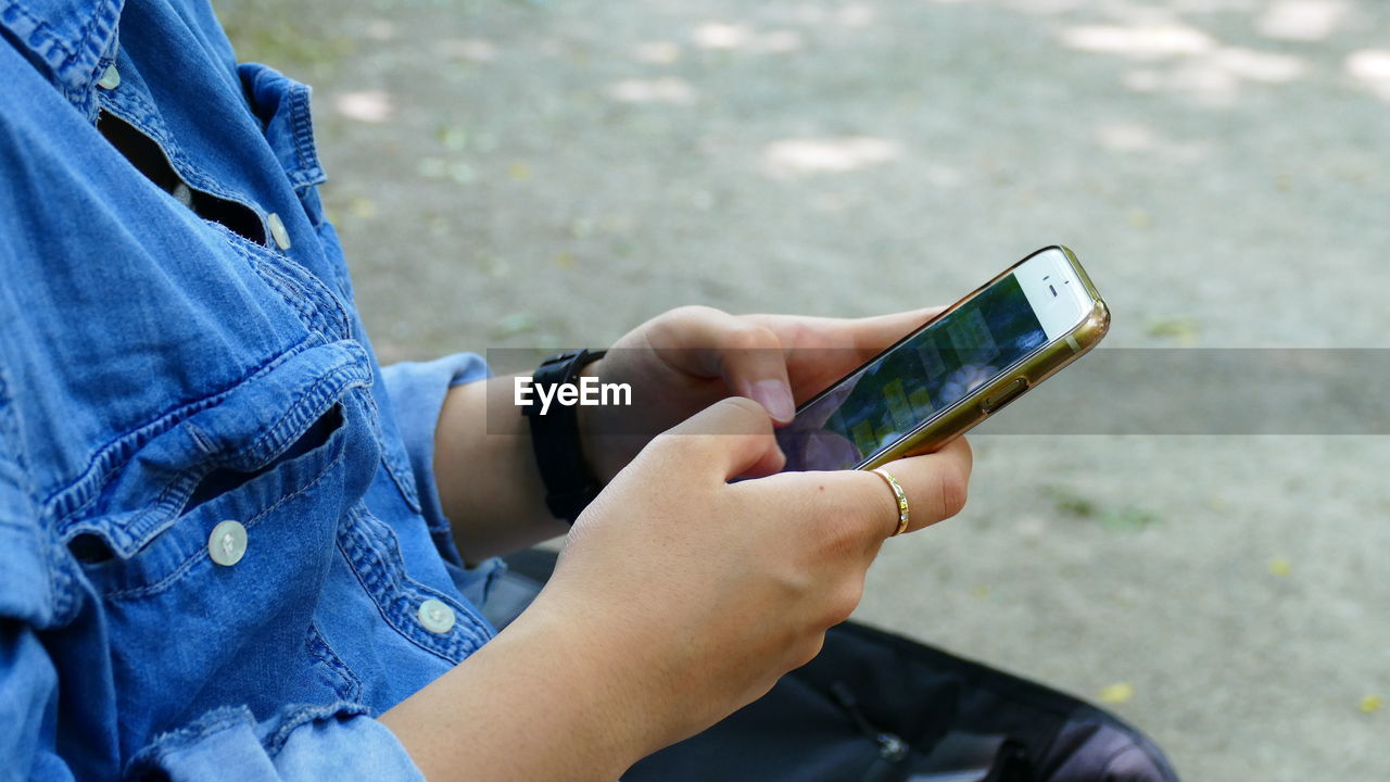 Midsection of woman using mobile phone