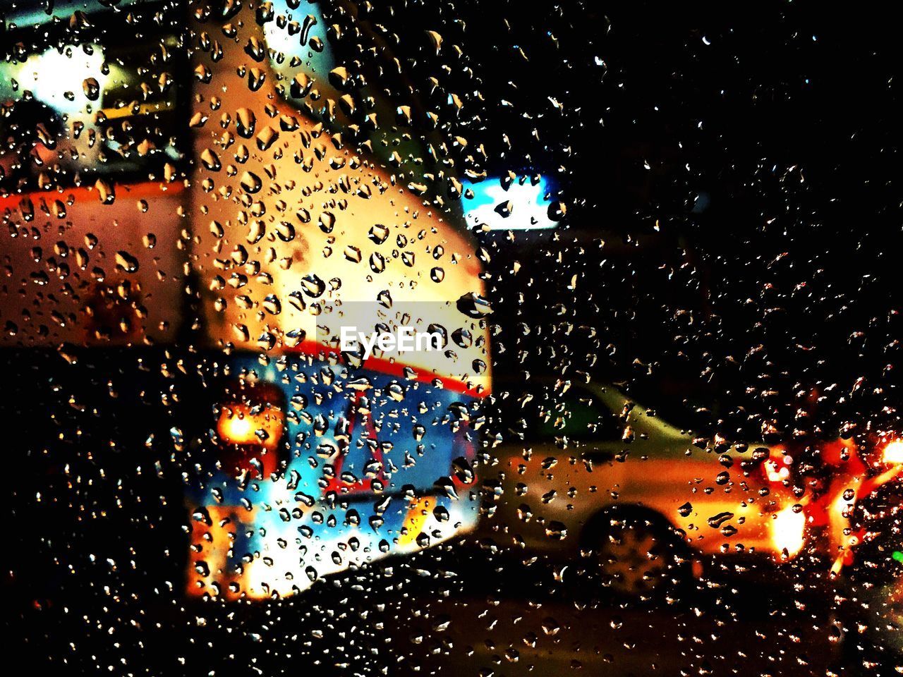 CLOSE-UP OF WATER DROPS ON GLASS AGAINST SKY