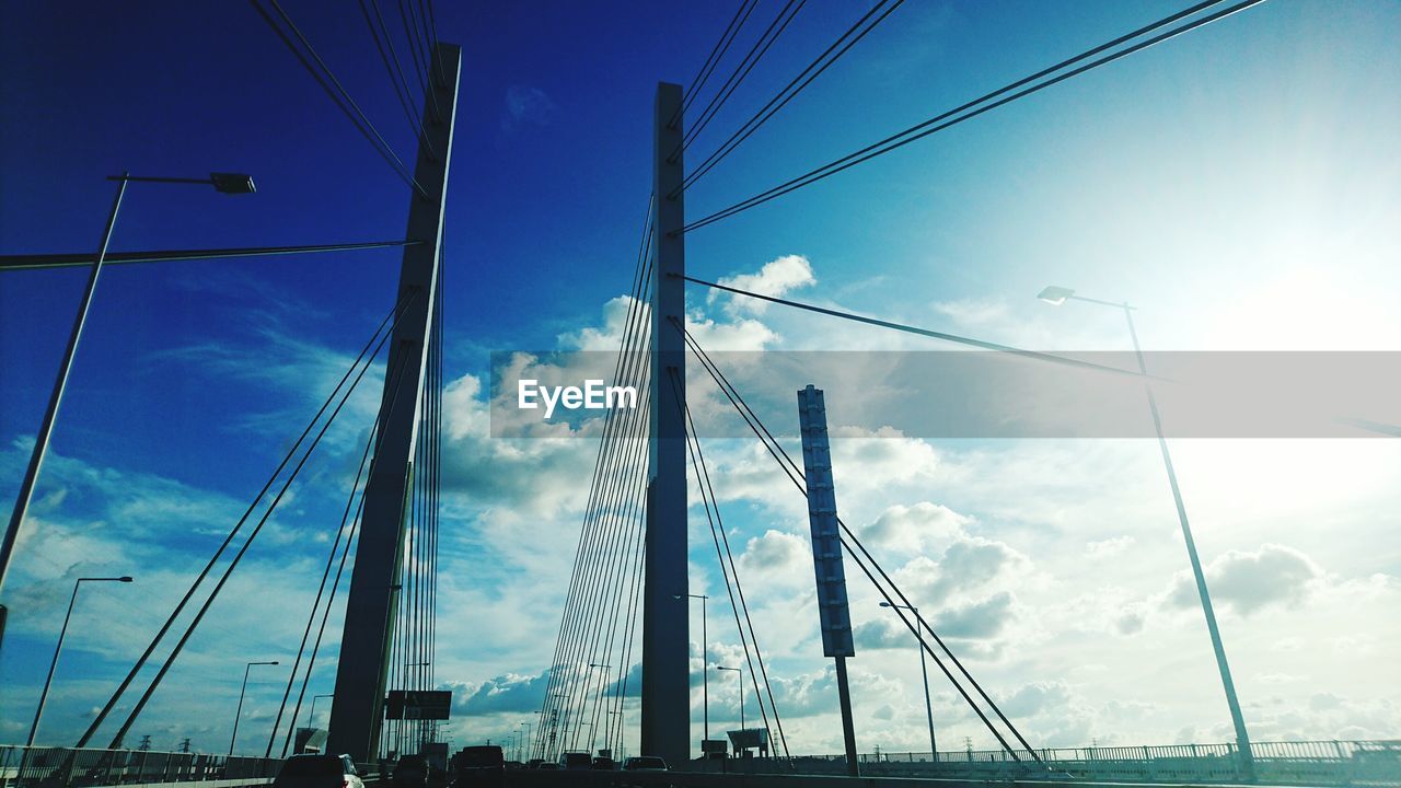 Low angle view of cables against blue sky