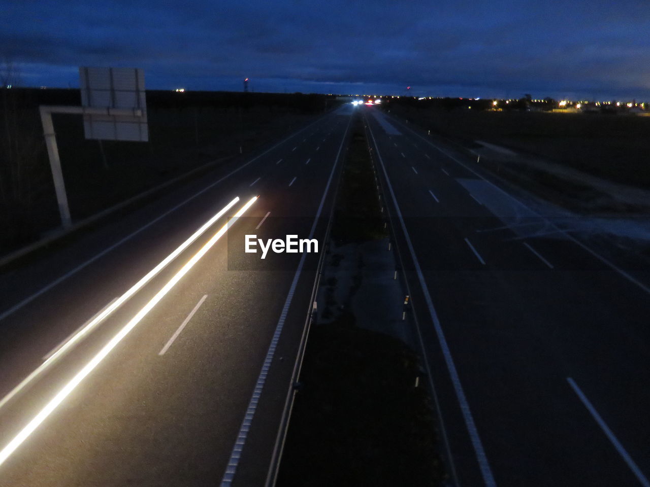 High angle view of light trails on highway at night