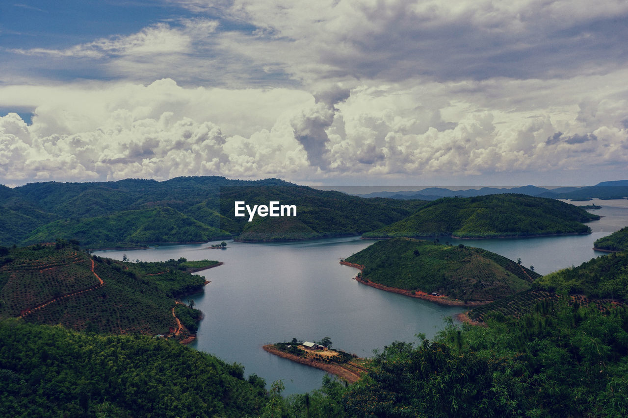 High angle view of river amidst mountains against sky