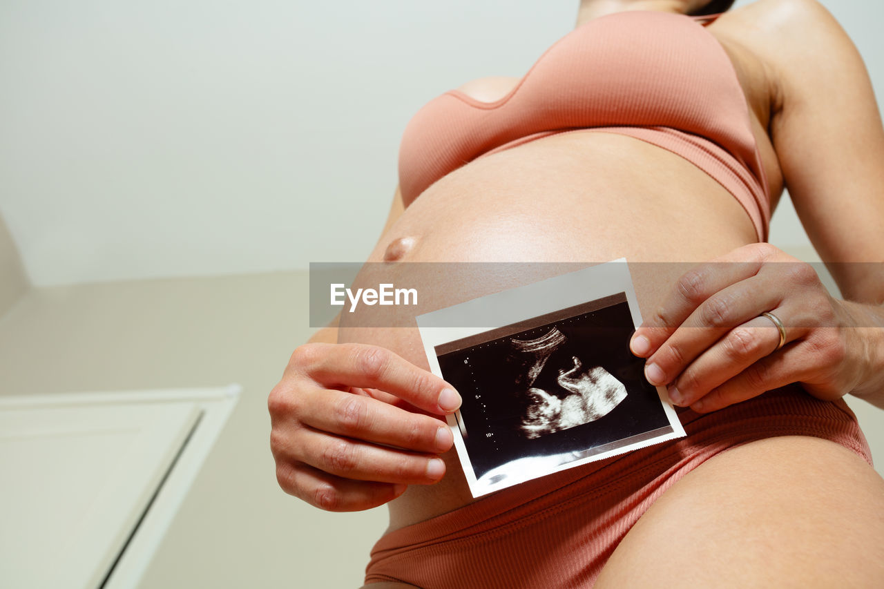 midsection of woman using smart phone