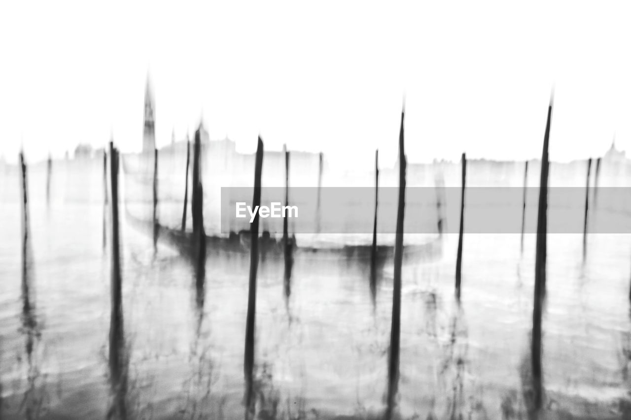 PANORAMIC VIEW OF WOODEN POSTS IN WATER AGAINST SKY