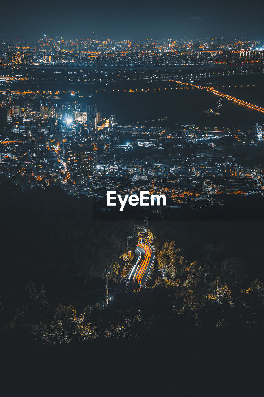 High angle view of illuminated buildings in city at night