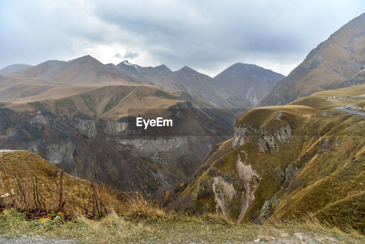 Scenic view of landscape and mountains against sky