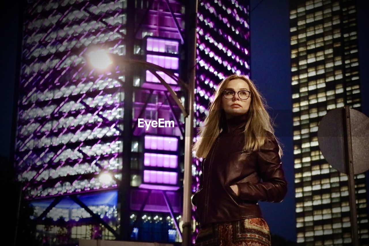 Female portrait, buildings at night