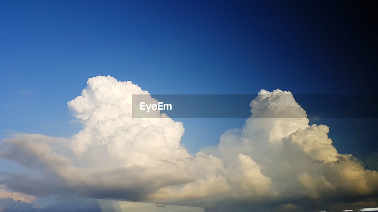 LOW ANGLE VIEW OF CLOUDS IN BLUE SKY