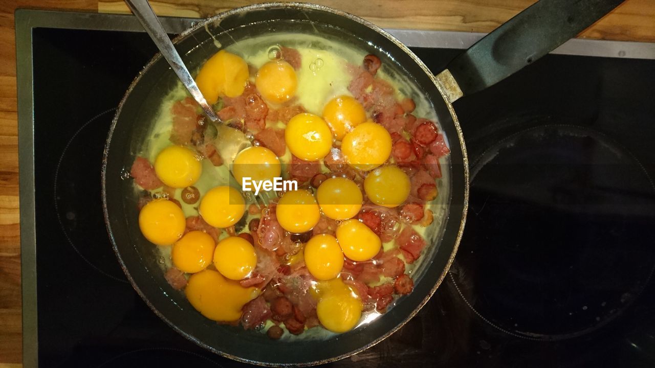 Directly above shot of vegetables with eggs being cooked in frying pan