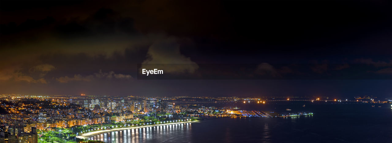 Illuminated rio de janeiro cityscape against sky at night