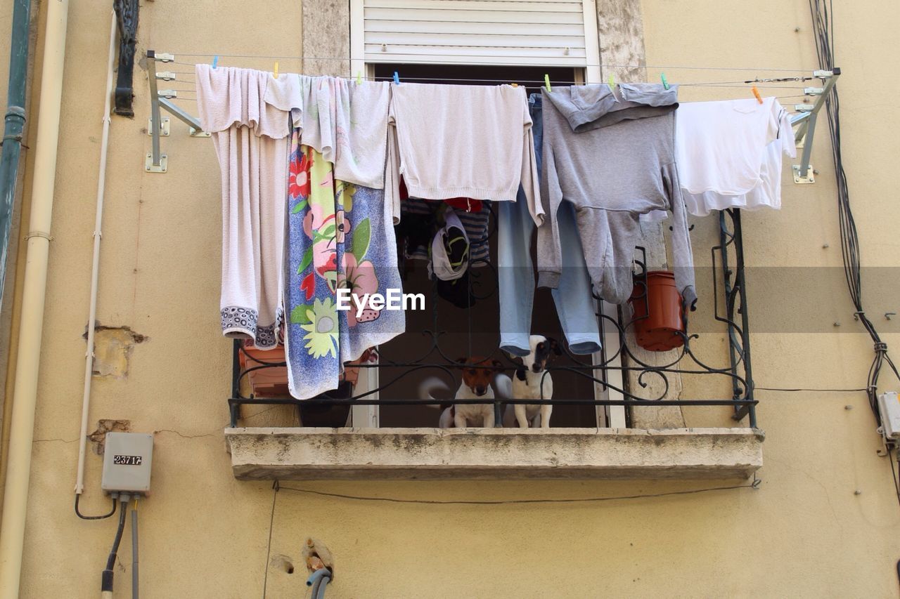 CLOTHES DRYING ON CLOTHESLINE AGAINST BUILDING