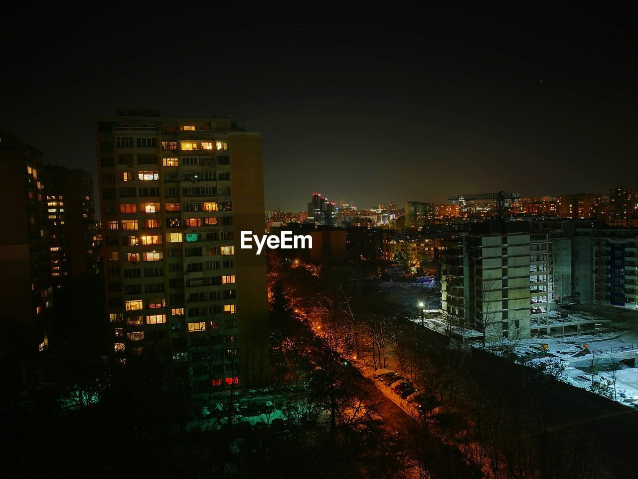 VIEW OF ILLUMINATED CITY AT NIGHT